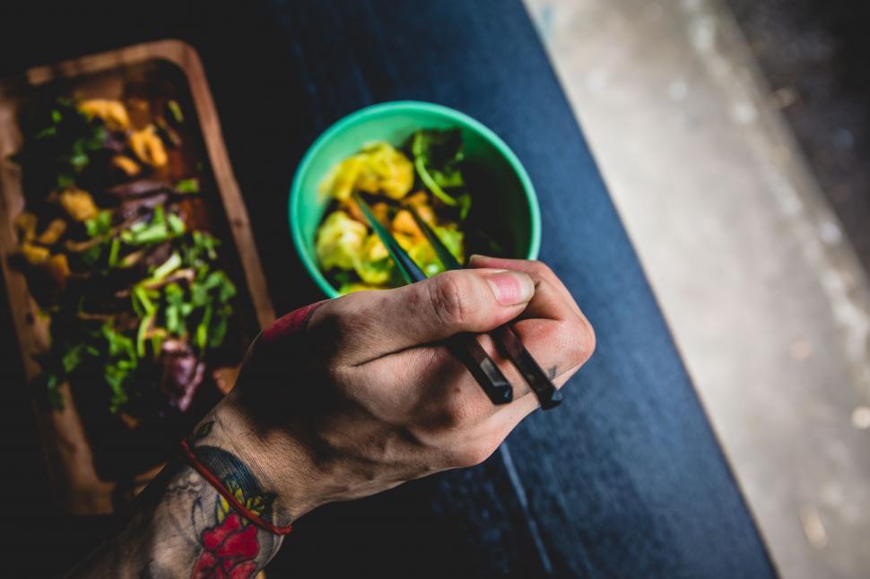 Free Image of Person Holding Fork Over Bowl of Food 