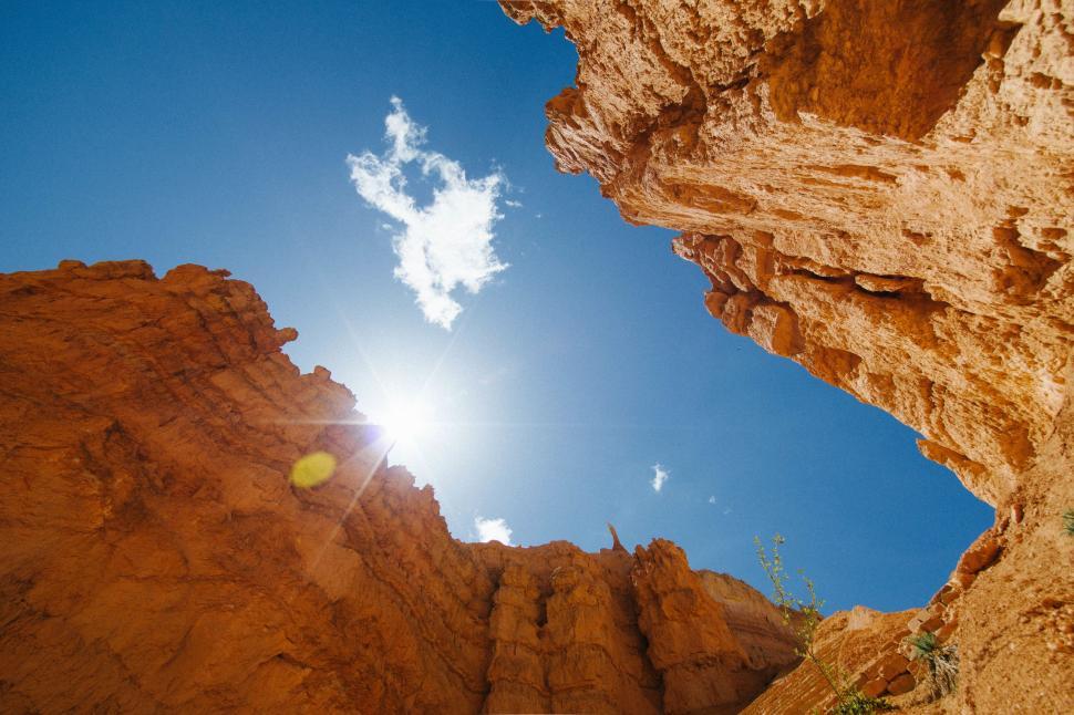 Free Image of Sun Shining Brightly Through Rocks 