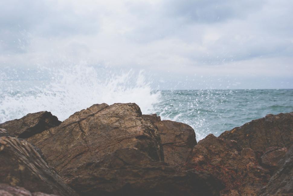 Free Image of Person Standing on Rock Near Ocean 