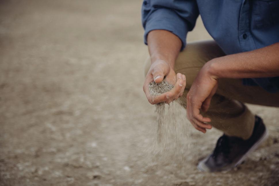 Free Image of Man Kneeling Down Holding Object 