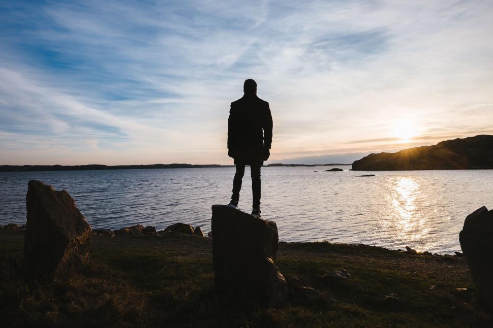 Free Image of Person Standing on Rock Near Water 