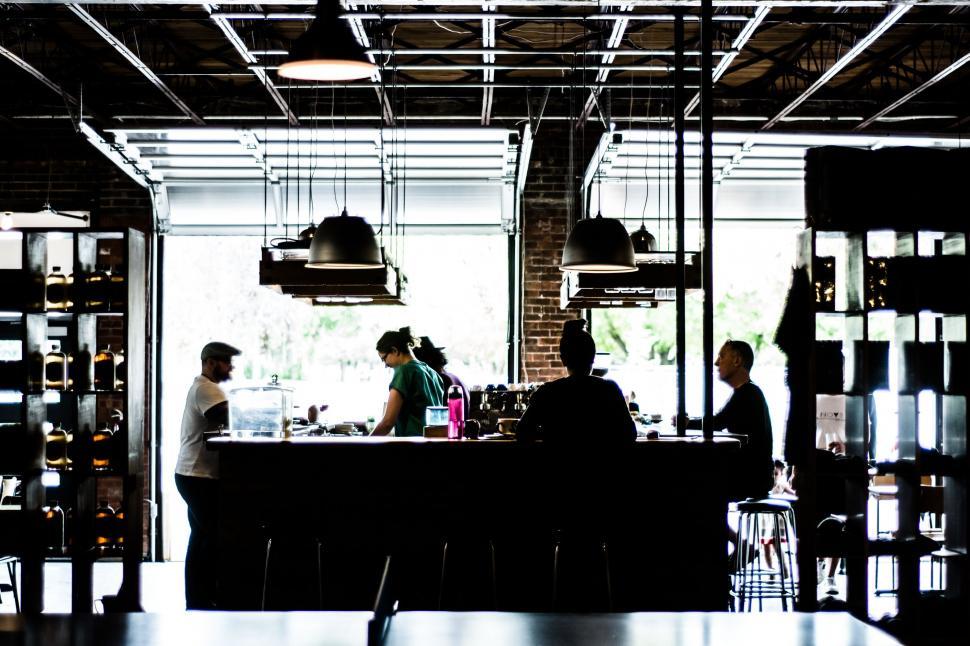 Free Image of Group of People Sitting at a Bar in a Restaurant 