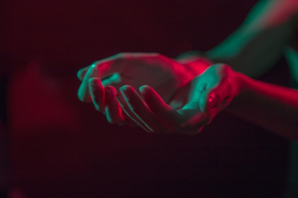 Free Image of Interlocked Hands in Dimly Lit Room 