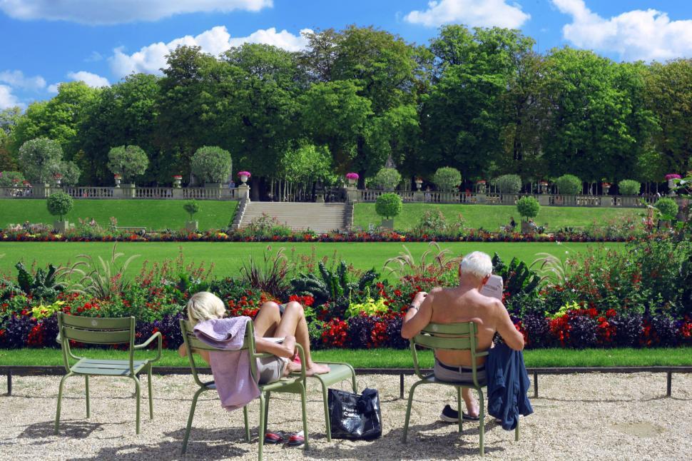 Free Image of Couple Sitting on Chairs in Park 