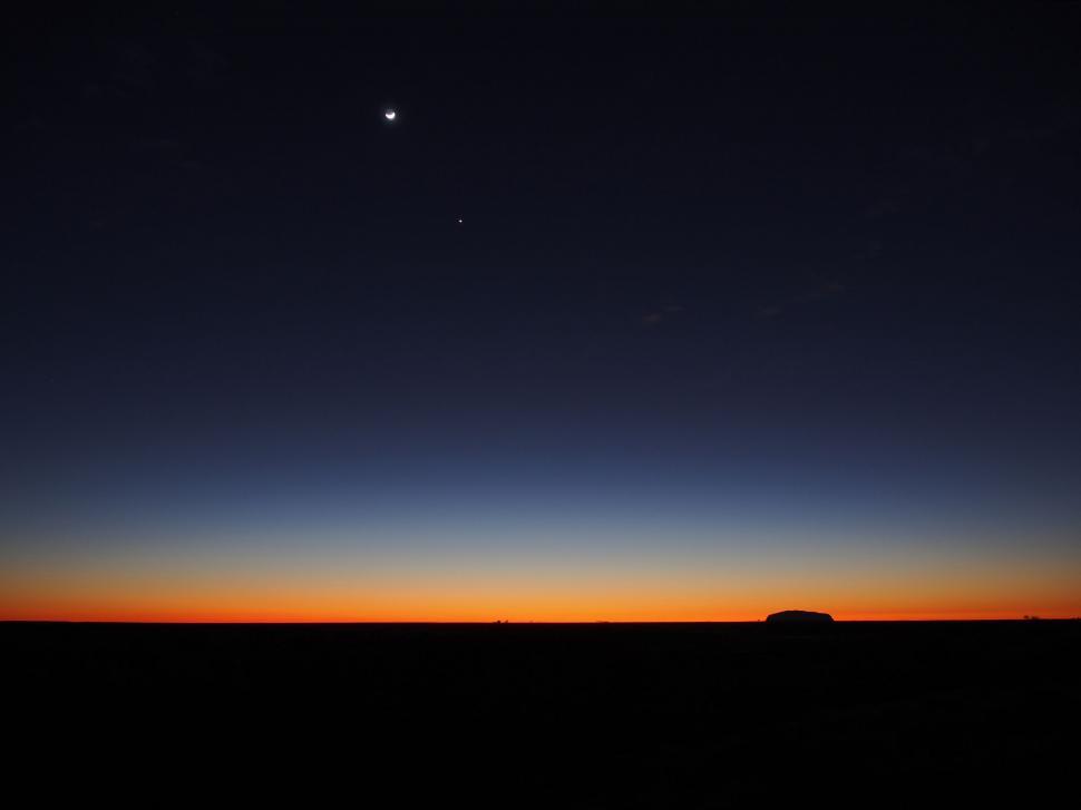 Free Image of Sun Setting Behind Distant Object 