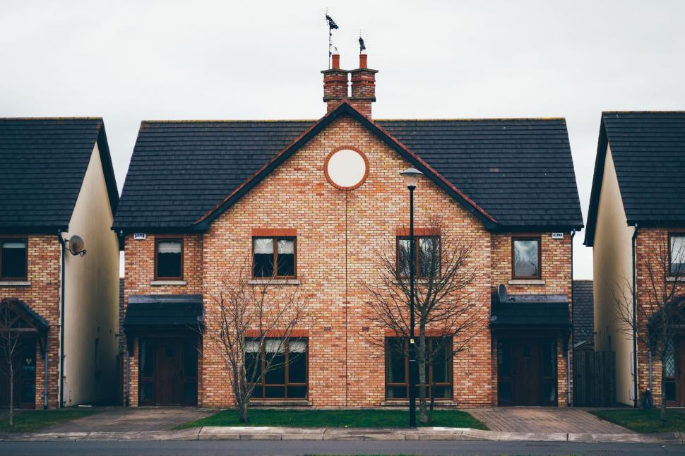 Free Image of Row of Brick Houses With Clock 