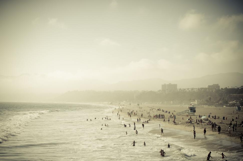 Free Image of Group of People Standing on Beach by Ocean 