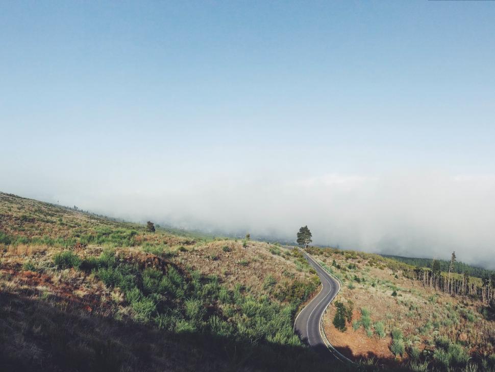 Free Image of Winding Road on Hill in Middle of Day 