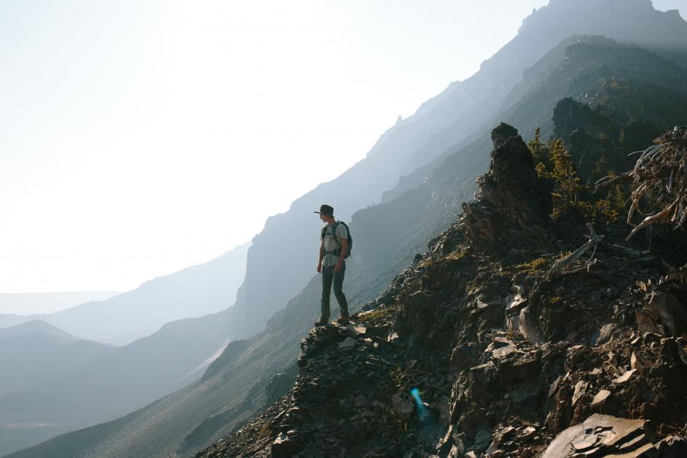 Free Image of Man Standing on Top of Rocky Mountain 