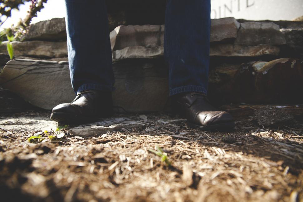 Free Image of Person Standing on Top of Pile of Dirt 
