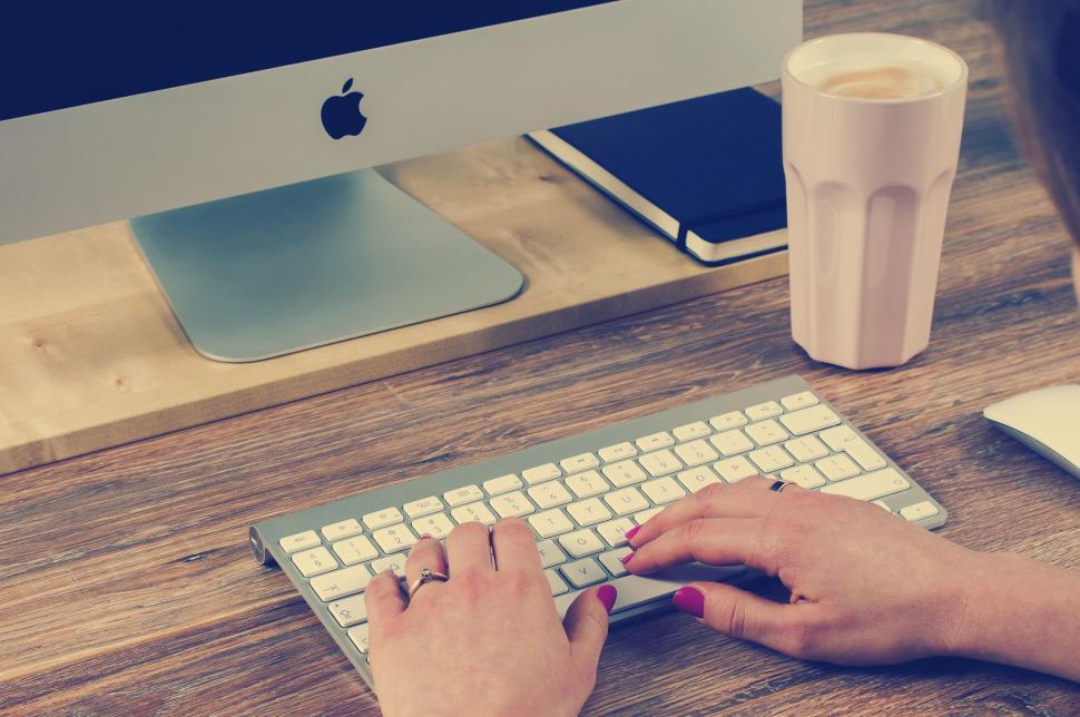 Free Image of Person Typing on Keyboard at Desk 