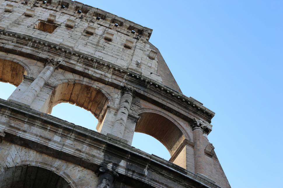 Free Image of Bird Flying Over Old Building 