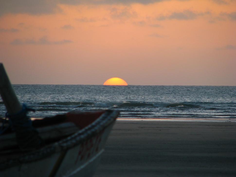 Free Image of Boat Parked on Sandy Beach Beside Ocean 