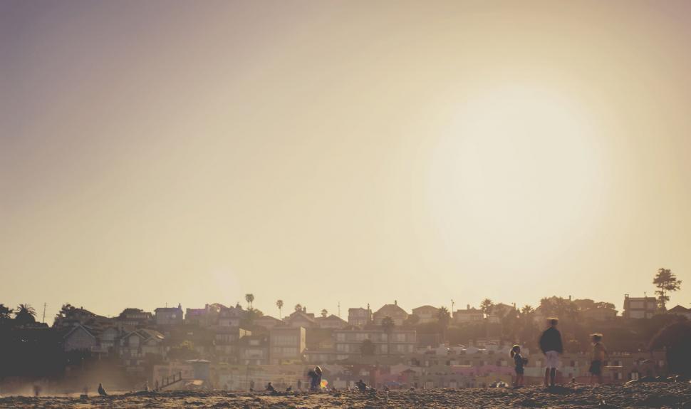 Free Image of Group of People Standing on Sandy Beach 
