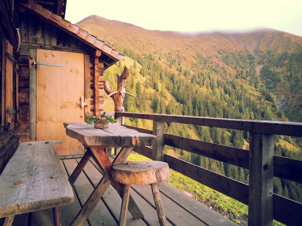 Free Image of Wooden Deck With Table and Two Stools 