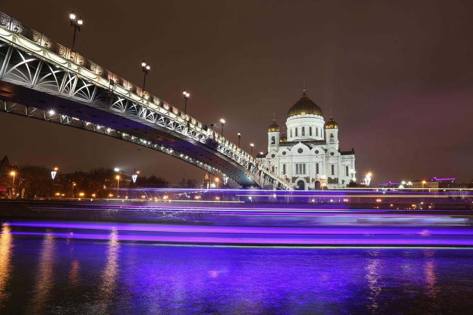 Free Image of Bridge Spanning Over Body of Water With Distant Building 