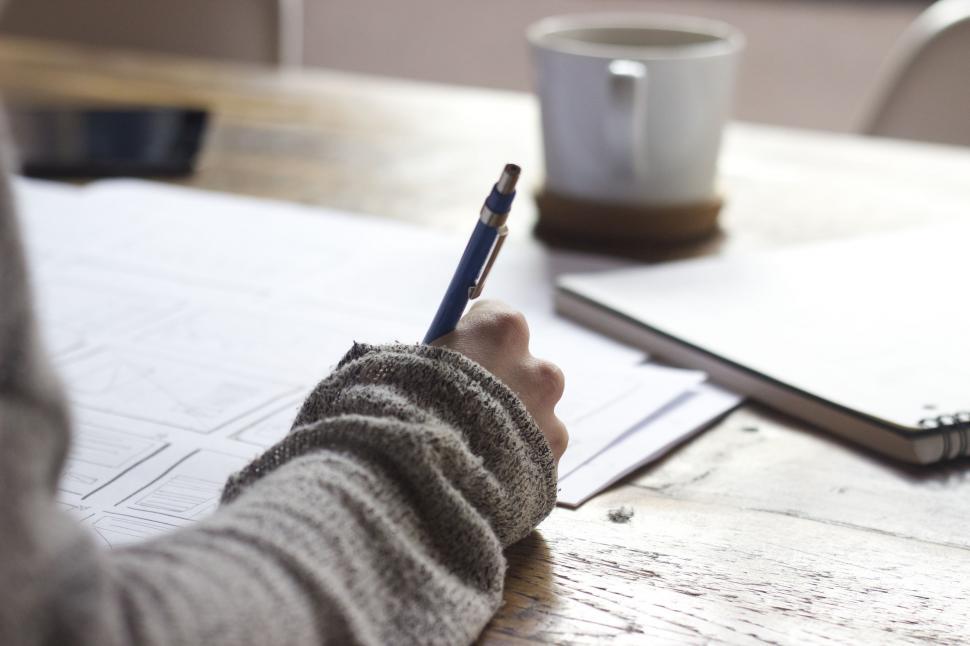Free Image of Person Writing on a Piece of Paper With a Pen 