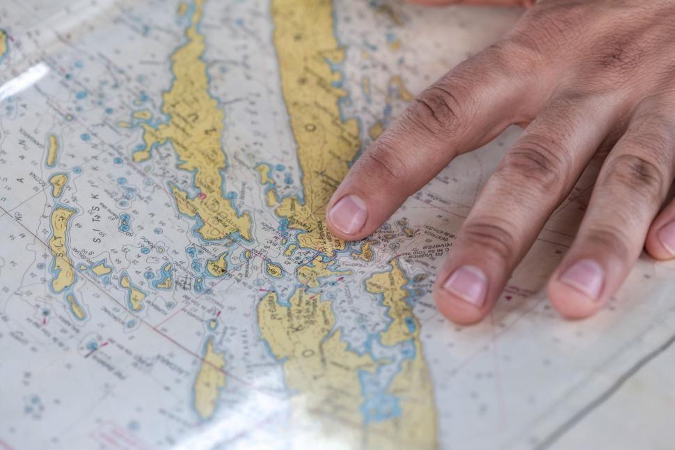 Free Image of Persons Hand on Top of Map 