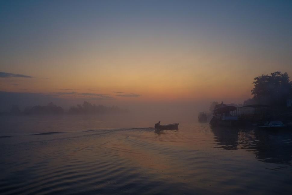 Free Image of Boat Floating on Lake at Sunset 