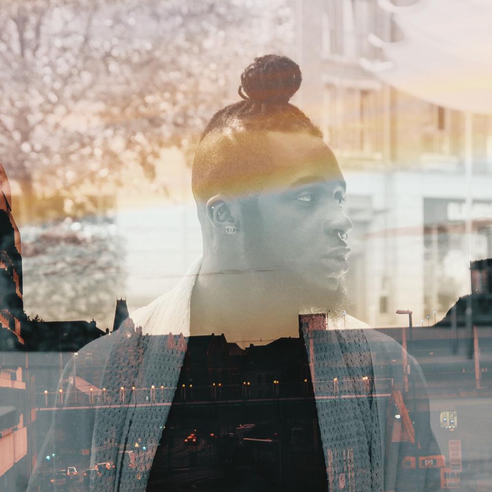 Free Image of Man Standing in Front of a Window 