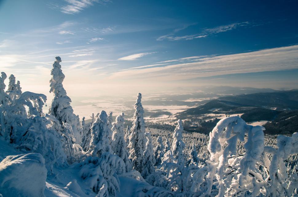 Free Image of Person Riding Snowboard Down Snow Covered Slope 