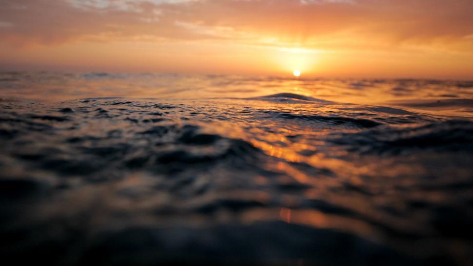 Free Image of Sun Setting Over Body of Water 