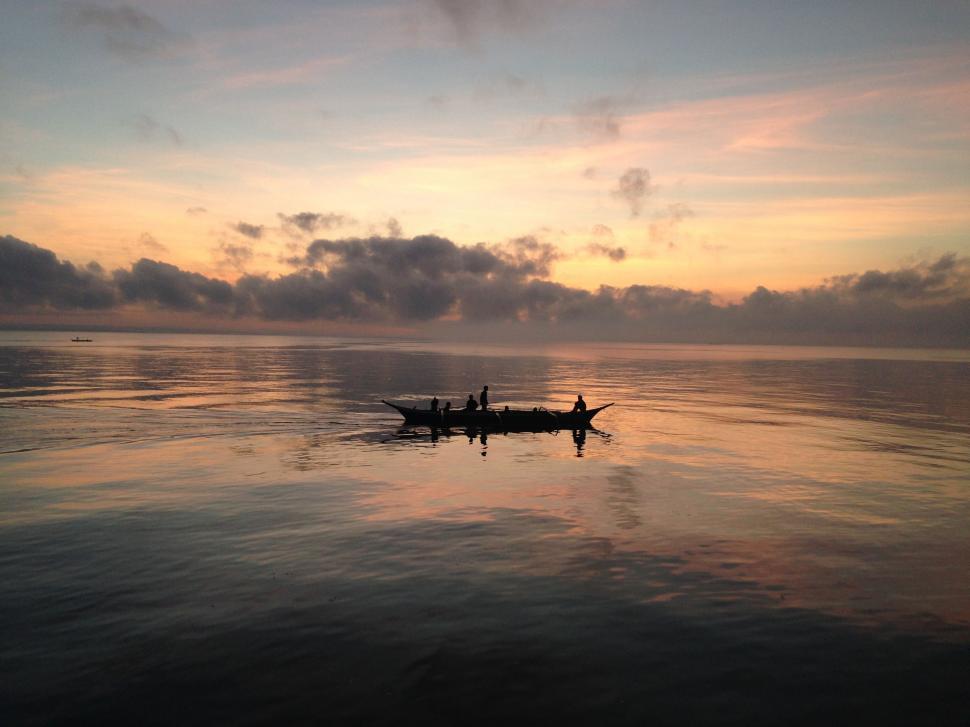 Free Image of Two People Rowing a Boat on a Lake 