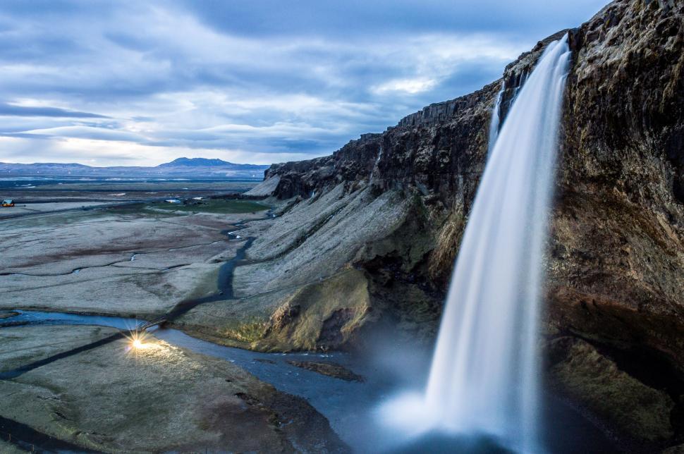 Free Image of Majestic Waterfall Cascading in Rocky Terrain 
