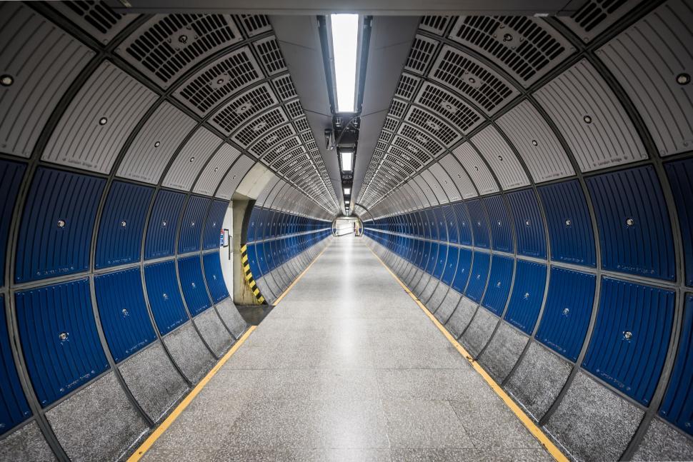 Free Image of Long Hallway With Blue Doors and White Floor 