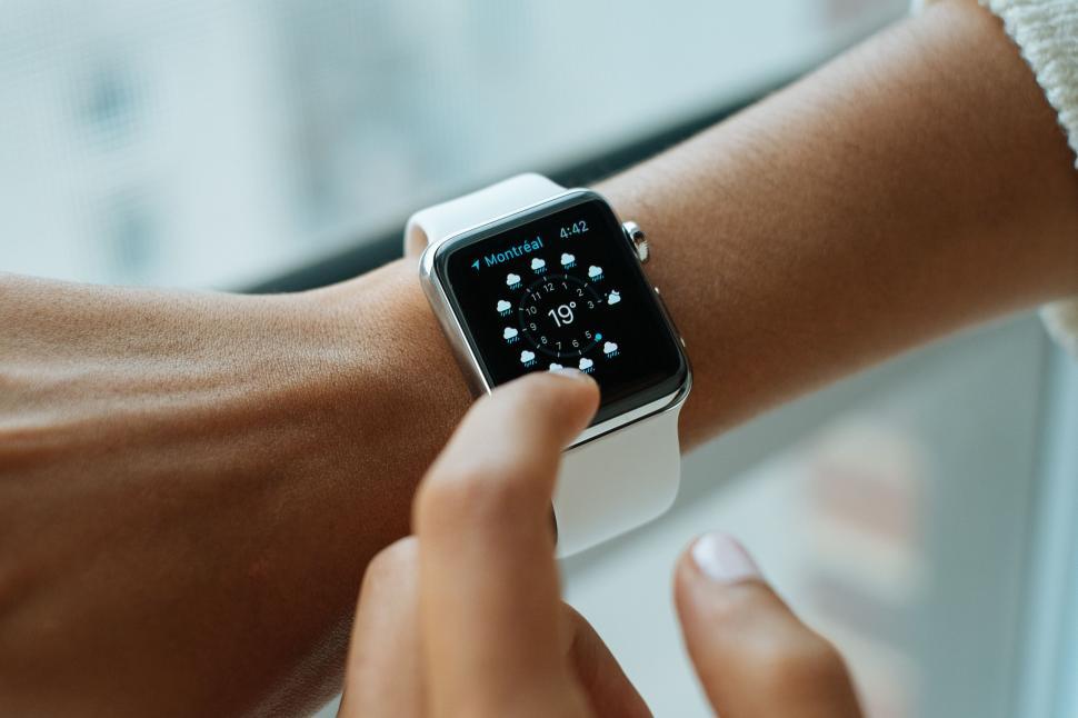 Free Image of Woman Holding Smart Watch 
