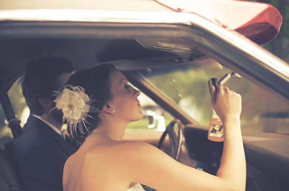 Free Image of Woman Sitting in Car Holding Cell Phone 