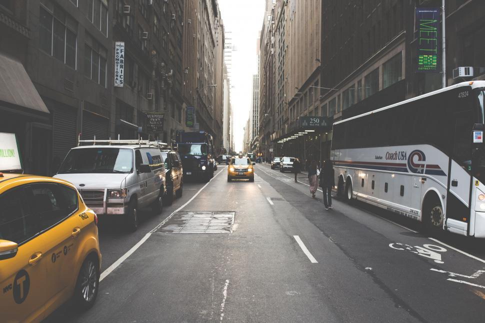 Free Image of Bustling City Street Next to Tall Buildings 