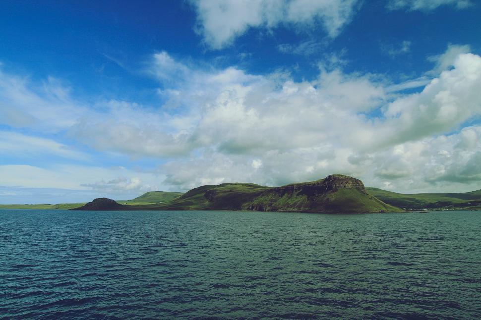Free Image of Majestic Mountain Overlooking Vast Water Body 