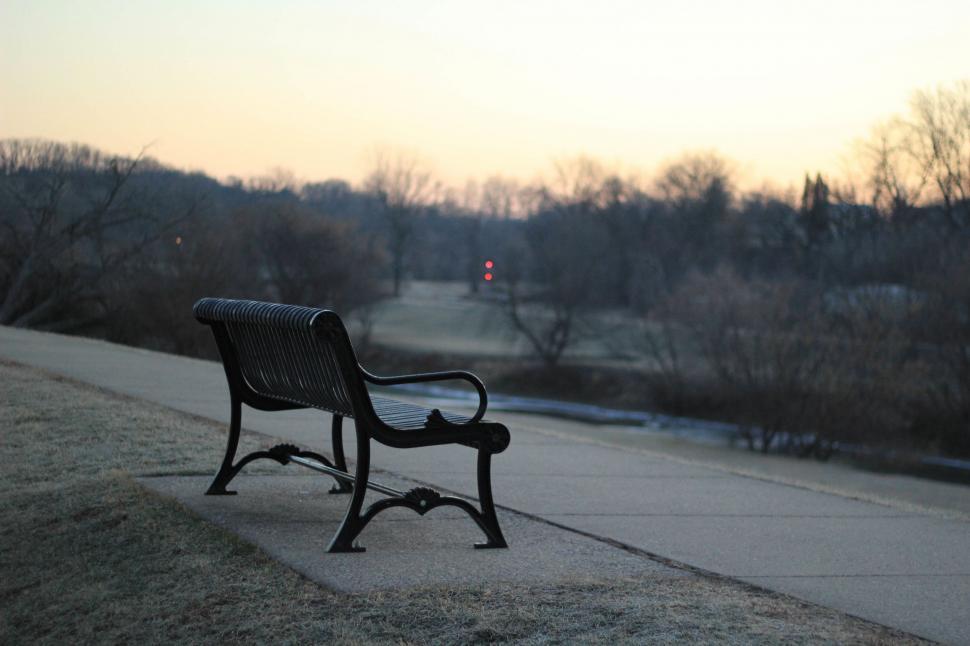 Free Image of Park Bench Alongside Road 