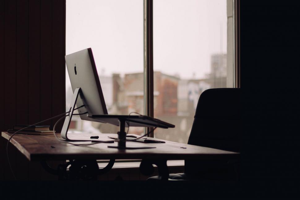 Free Image of Desk With Computer in Front of Window 