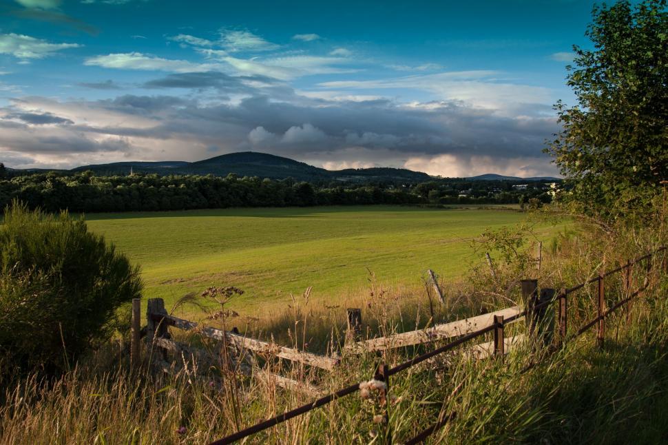Free Image of Field With Fence and Mountains 