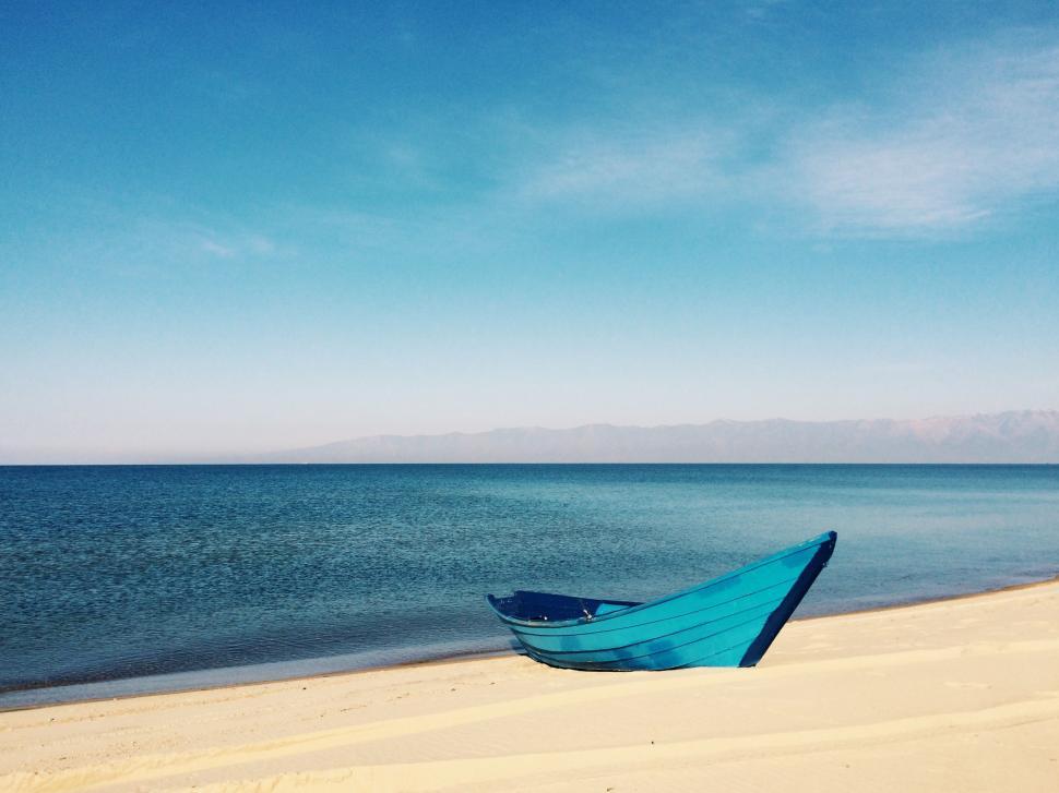 Free Image of Blue Boat on Sandy Beach 