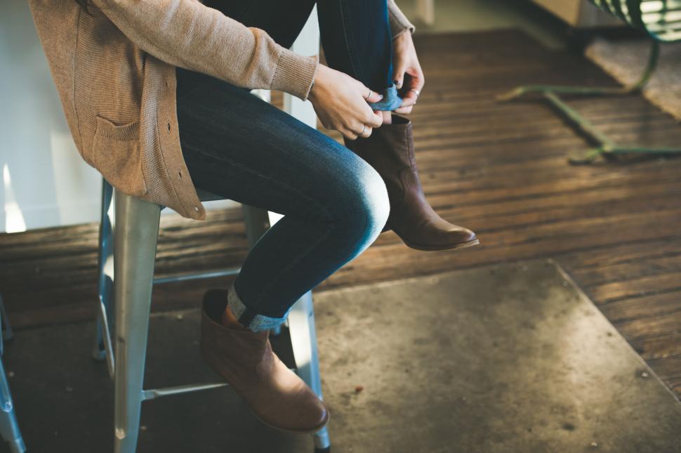 Free Image of Woman Sitting on Chair Holding Cell Phone 