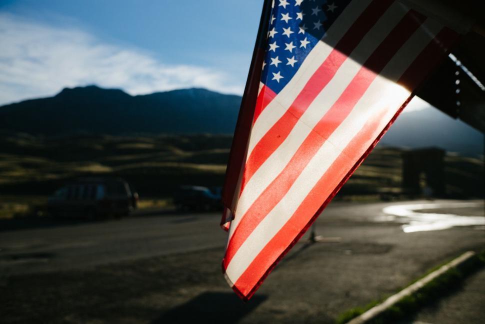 Free Image of Large American Flag Hanging From Side of Building 
