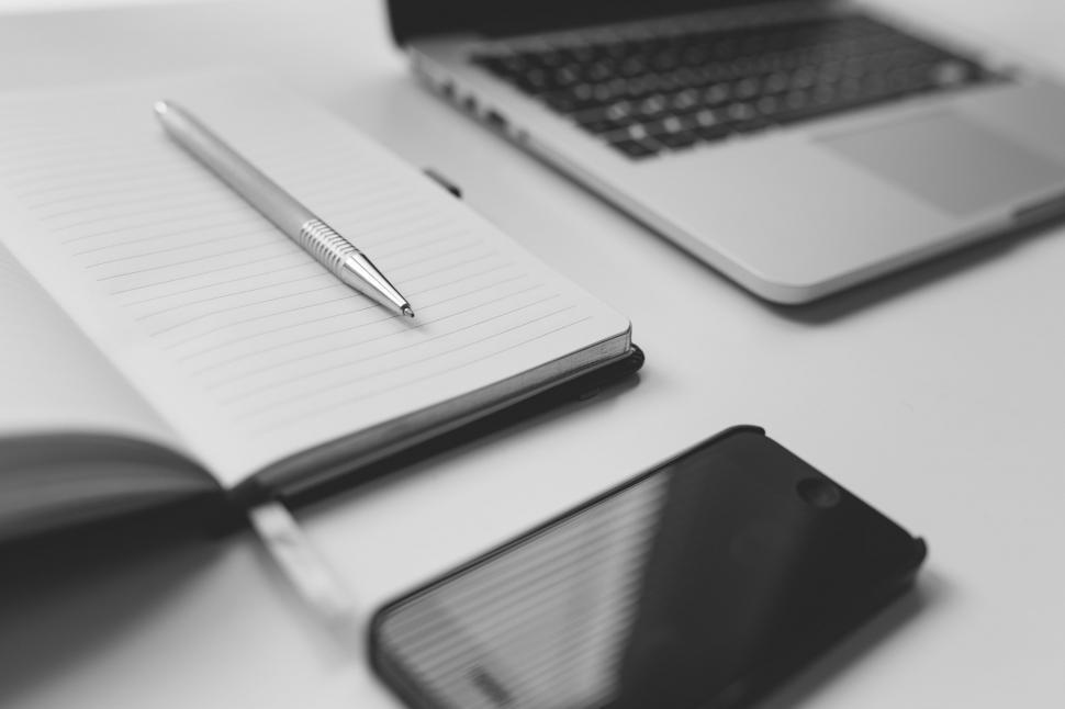 Free Image of Office Desk With Laptop, Notebook, and Cell Phone 