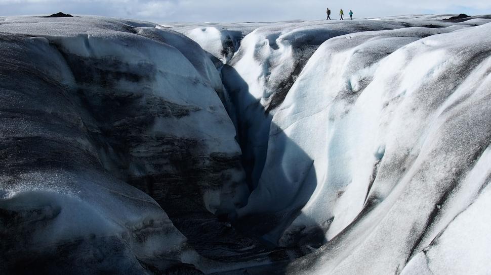 Free Image of Group of People Standing on Top of a Snow Covered Mountain 