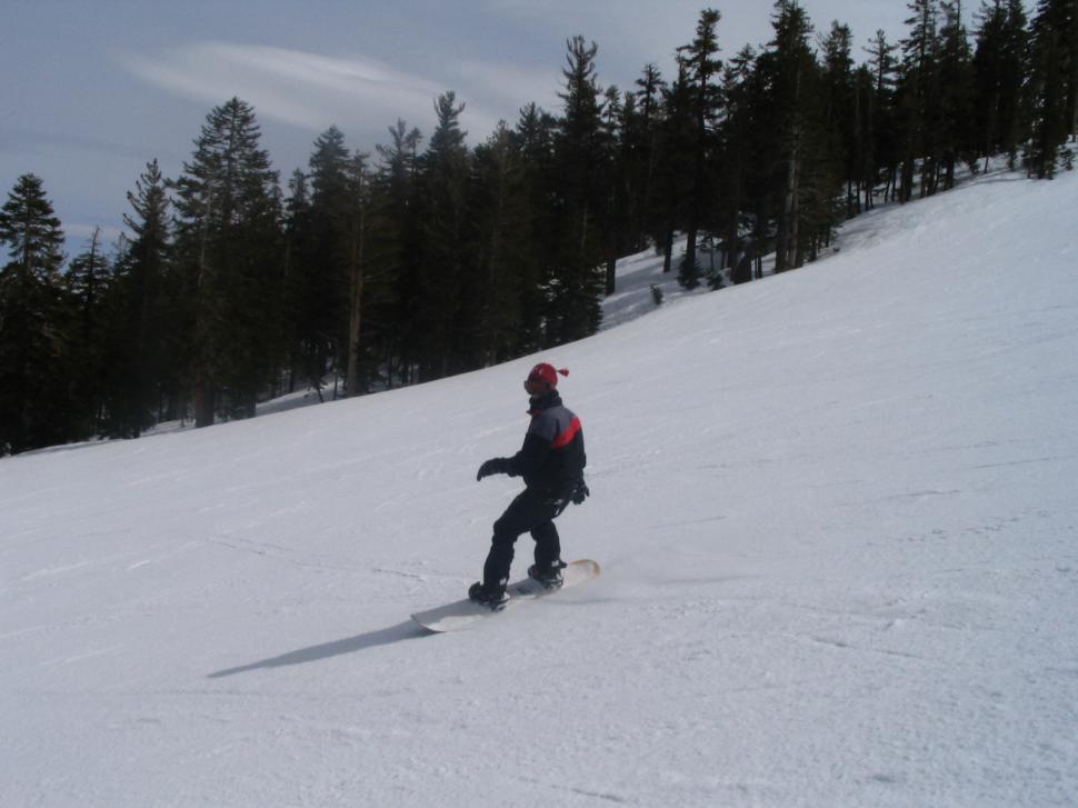 Free Image of Man Snowboarding Down Snow Covered Slope 