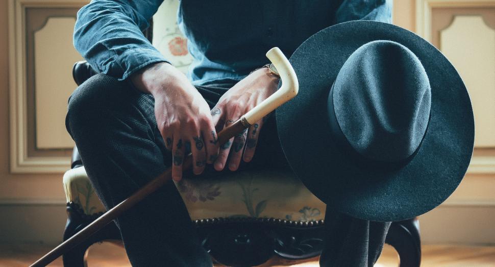 Free Image of Man Sitting in Chair With Top Hat On 
