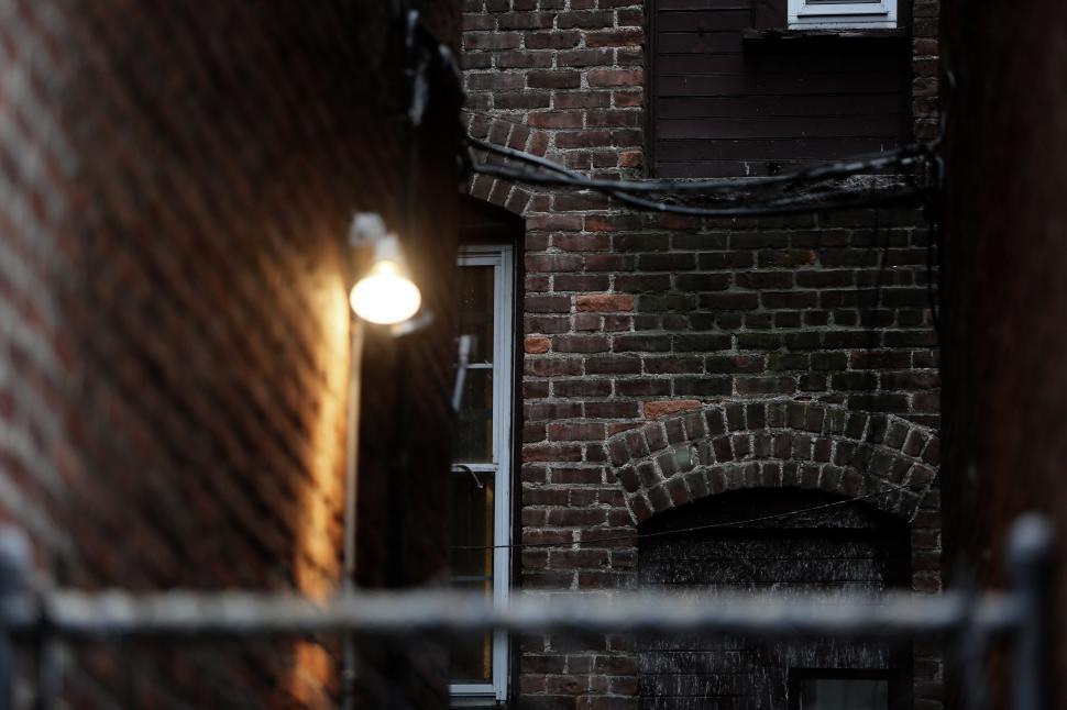 Free Image of Narrow Alleyway With Brick Wall and Window 