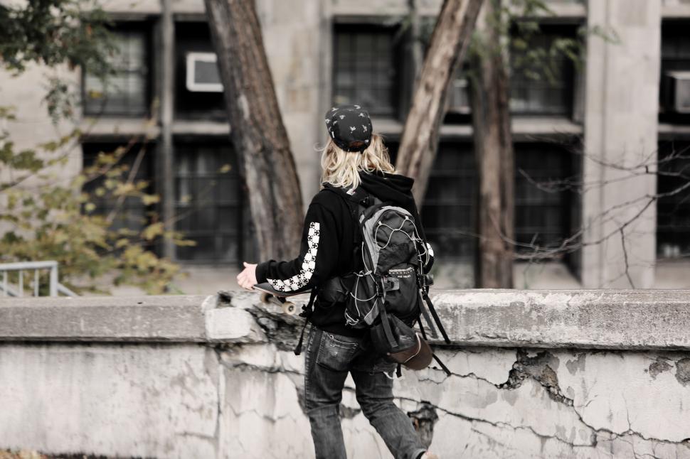 Free Image of Person Walking With Backpack on Bridge 
