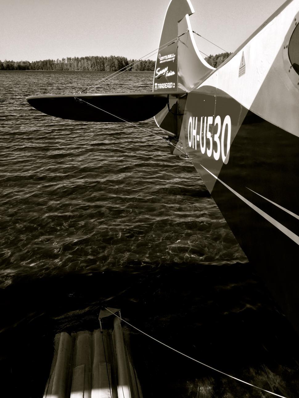 Free Image of Small Plane Flying Over Body of Water 