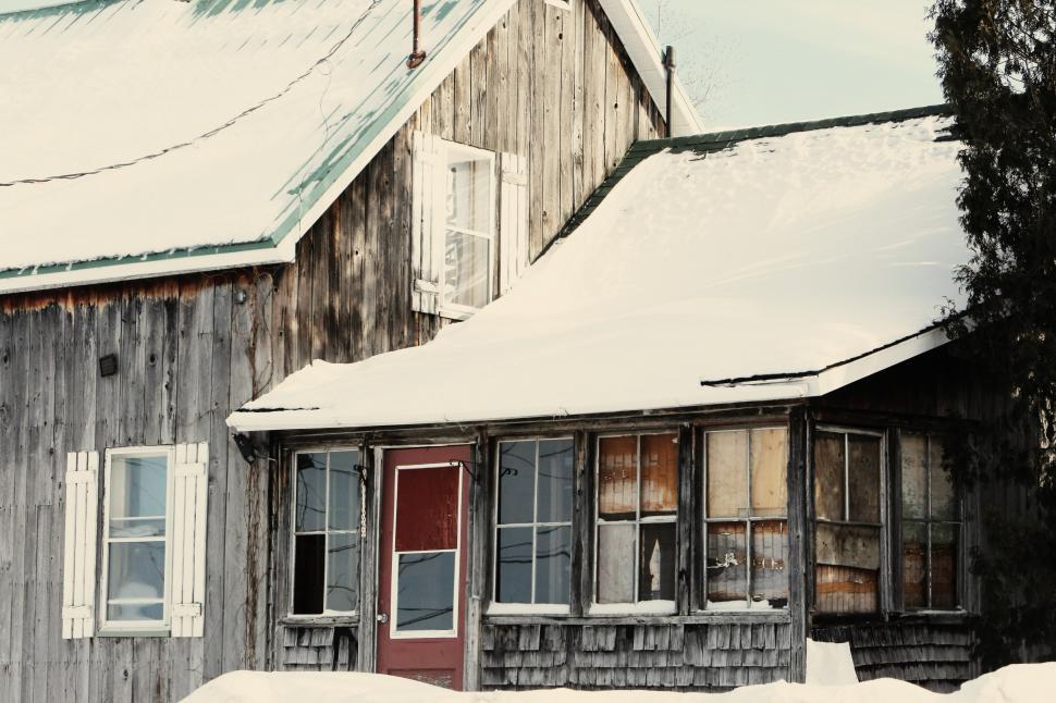 Free Image of Snow-Covered House Next to Tree 