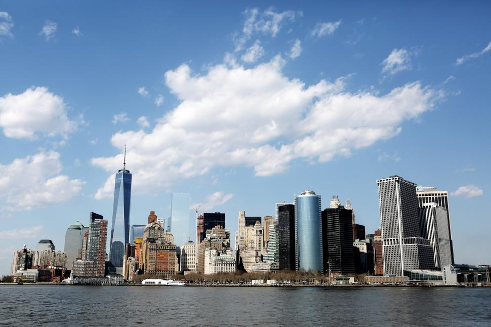 Free Image of City Skyline Overlooking Vast Body of Water 