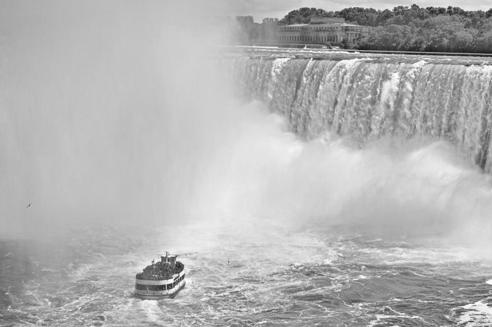 Free Image of Boat Sailing Near Waterfall 