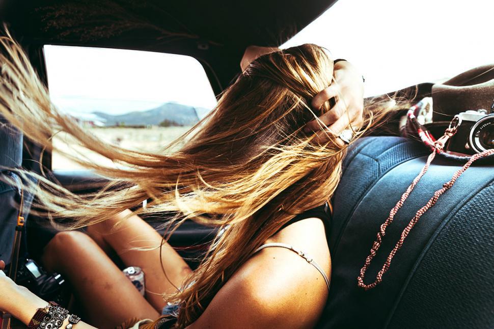 Free Image of Woman Sitting in Back Seat of Car 